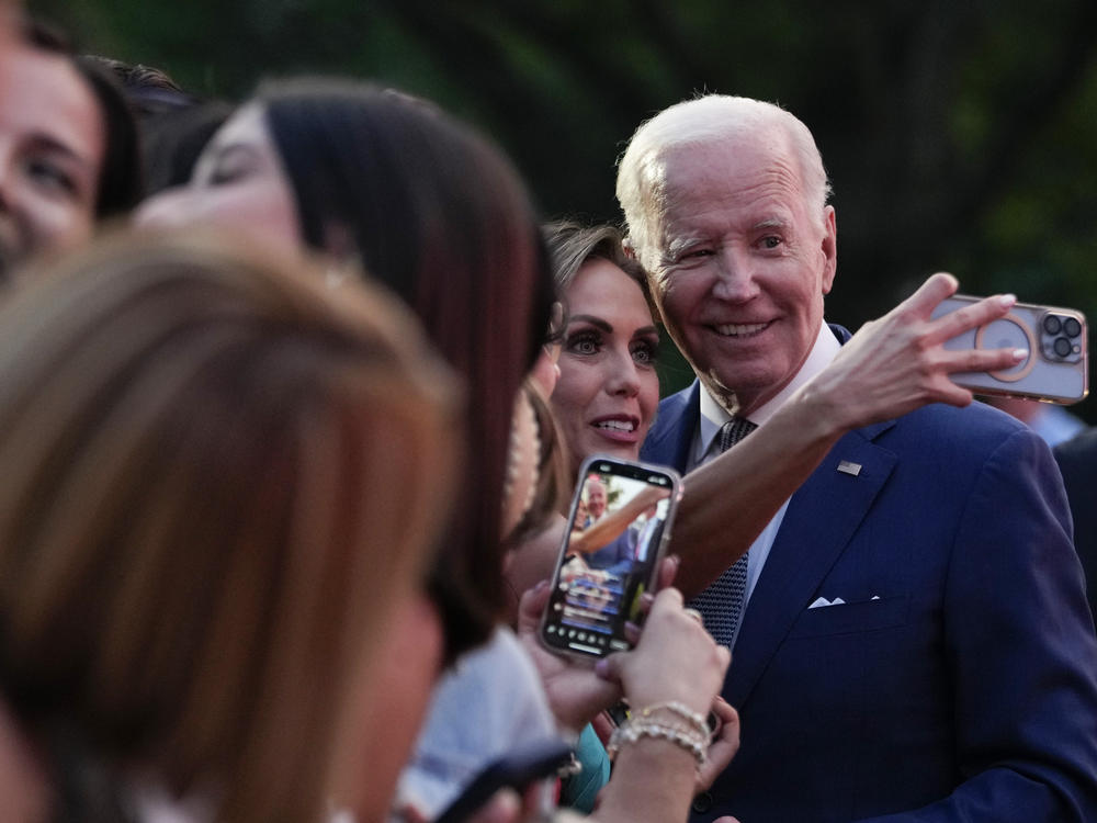 President Biden takes selfies with guests at a White House event on June 15.