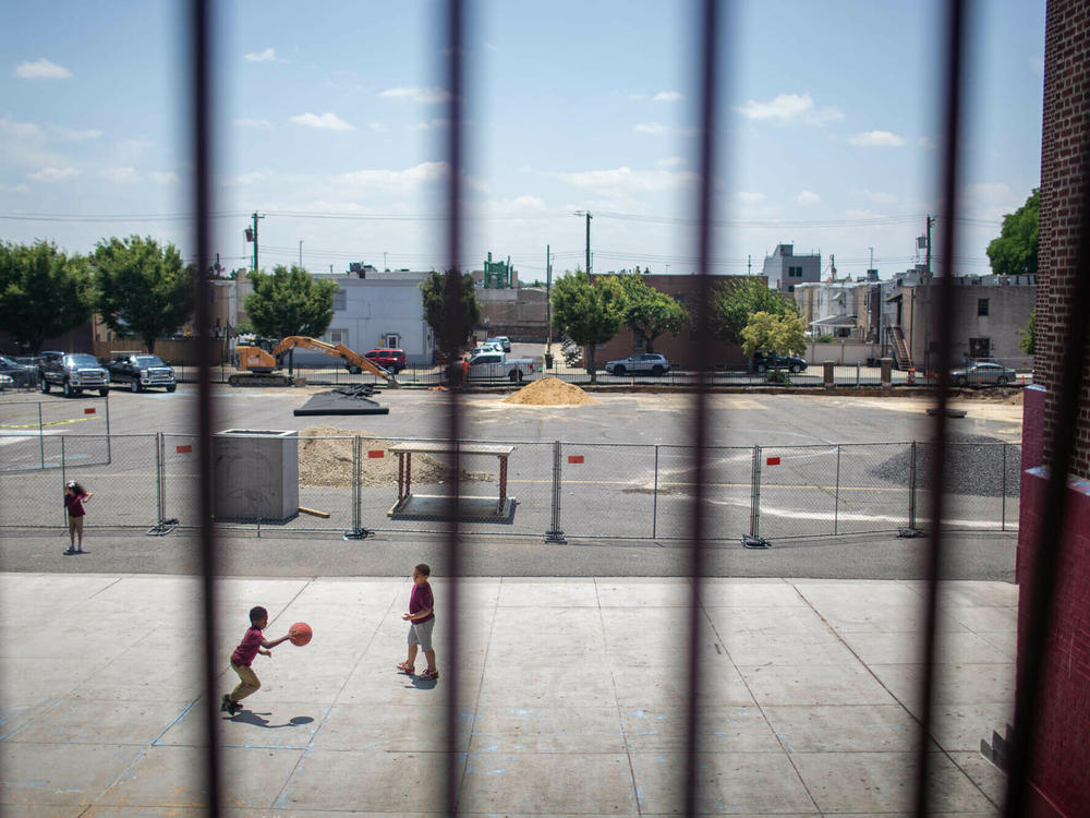 Students play basketball on the last day of the schoolyear at the F. Amedee Bregy School in South Philadelphia. The school broke ground on a renovation of its outdoor space that will include trees, landscaped rain gardens, a track and a basketball court.