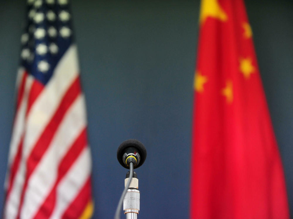 The U.S. and Chinese flags stand behind a microphone at the U.S. embassy in Beijing on April 9, 2009.