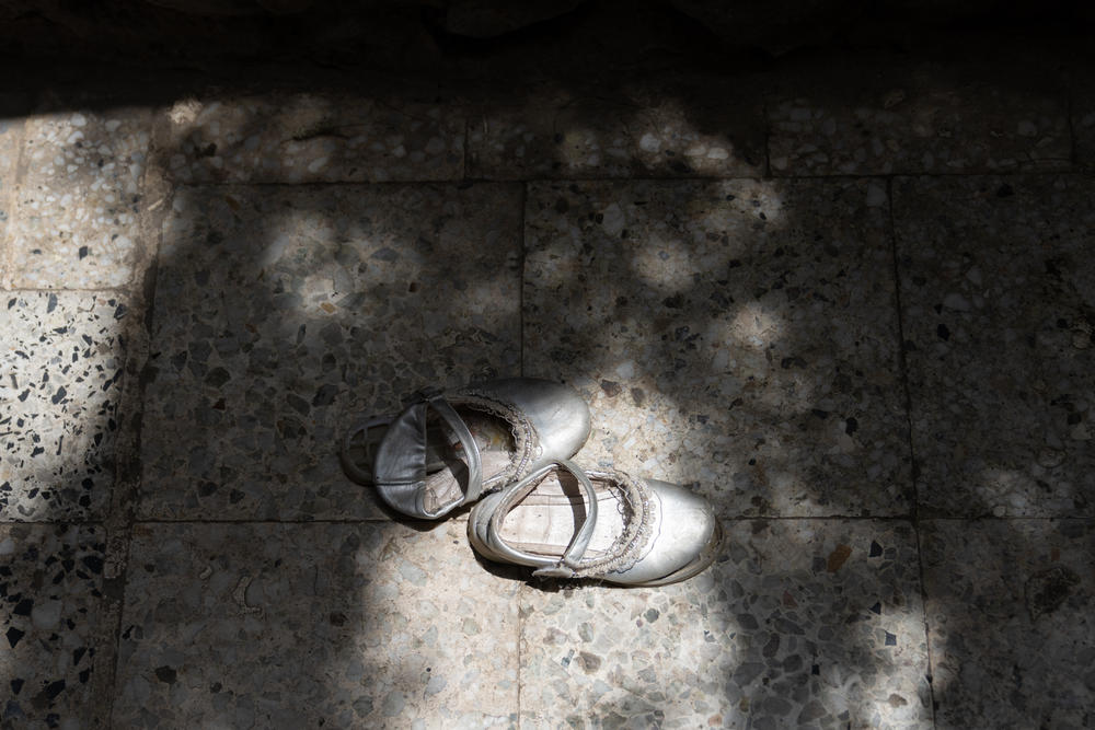 Abdullah's daughter's shoes sit outside their home in Al Dawah. While the front lines of Yemen's civil war are nearly on their doorstep, the family tries to go about their daily lives.