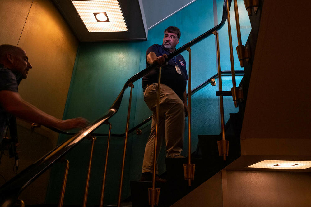 Erhard Koehler, Senior Technical Advisor for the ship, climbs the passenger staircase from the lobby to the lounge area.