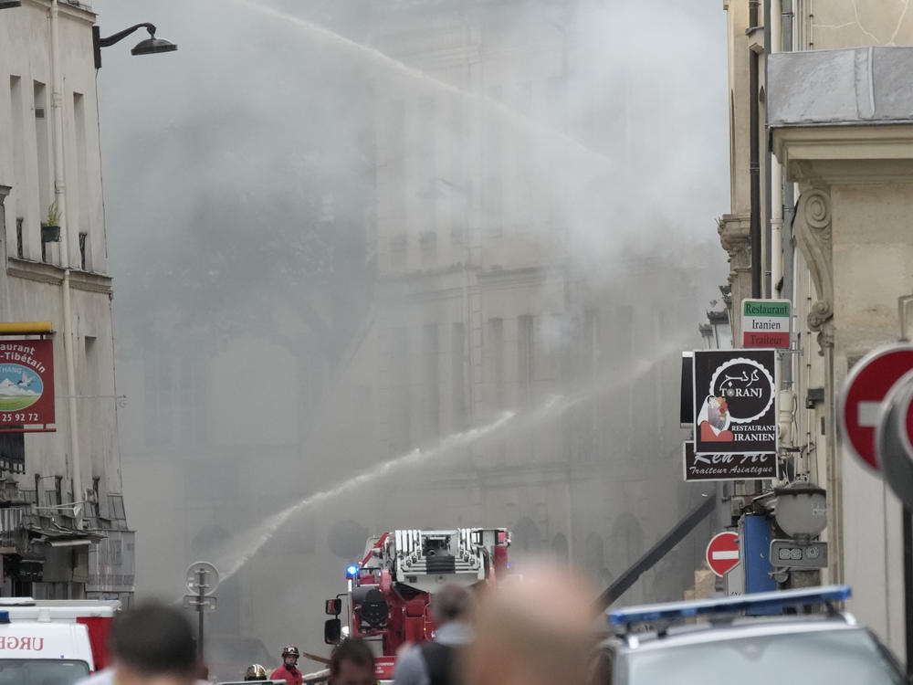 Firemen use a water canon as they fight a blaze following an explosion on Wednesday in Paris.