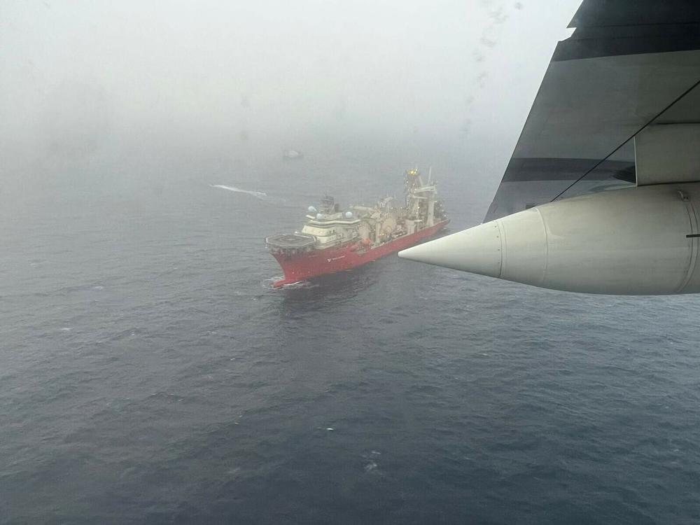 A photo provided by the U.S. Coast Guard on Wednesday shows a vessel searching for the lost submersible near the wreck site of the Titanic.