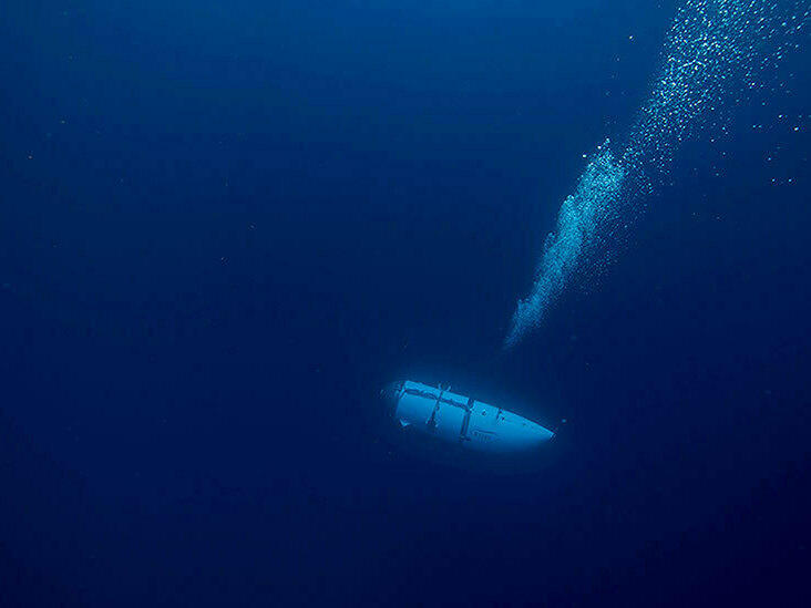 An undated photo shows a tourist submersible belonging to OceanGate descending into the ocean. Search and rescue operations for one of the company's submersibles, Titan, are continuing Wednesday.