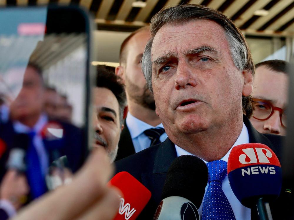 Brazil's former President Jair Bolsonaro speaks to the press as he leaves the Federal Senate in Brasília on June 21.