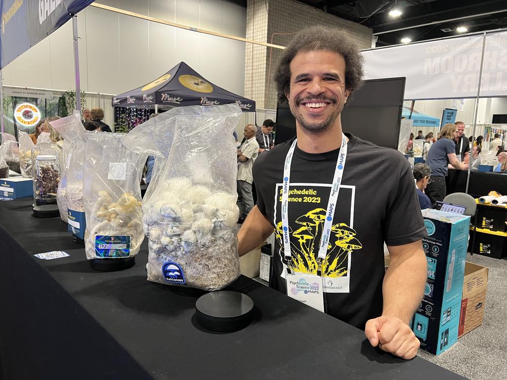 Zack Dorsett, the operations manager of Wonderbags, a company that sells mushroom starter kits, at his company's booth at the 