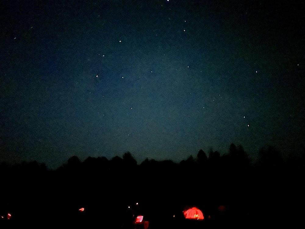 Red lamps, used to preserve night vision for observing, are seen on a field at the Cherry Springs Star Party in northern Pennsylvania.