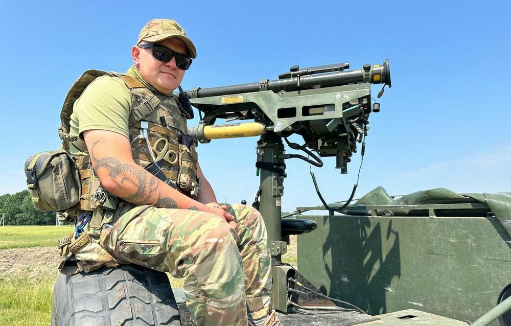 Yuri, a Ukrainian soldier, sits on the back of a Humvee next to a U.S. Stinger missile outside the capital Kyiv. He is part of a two-man mobile air defense team that guards against Russia missile and drone strikes. Ukraine's air defense is given high marks for limiting the damage inflicted by Russia's relentless airstrikes.