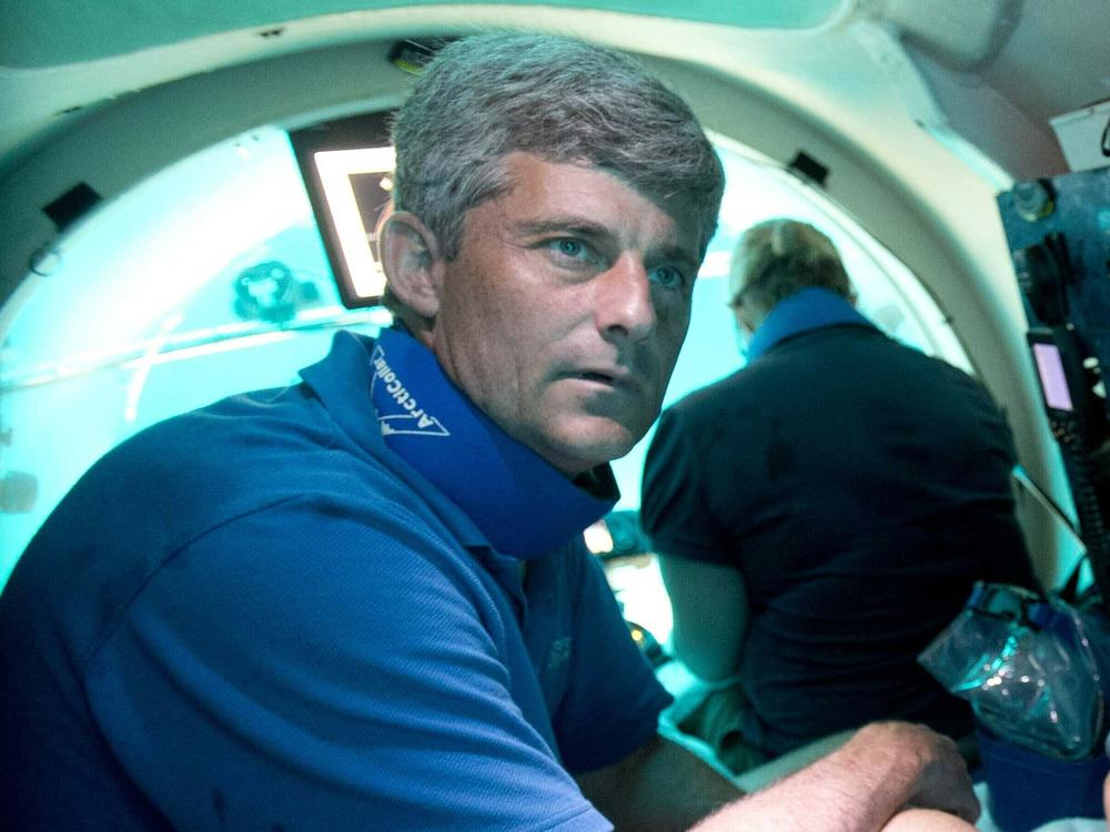 Stockton Rush, left, CEO and co-founder of OceanGate, is shown in June 2013 during a dive in the company's submersible, 