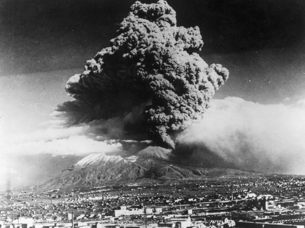 March 1944: A cloud of ash hangs over Vesuvius during its worst eruption in more than 70 years. In the foreground is the city of Naples. The nearby towns of Massa and San Sebastiano were destroyed by the flow of lava. (Photo by Keystone/Getty Images)