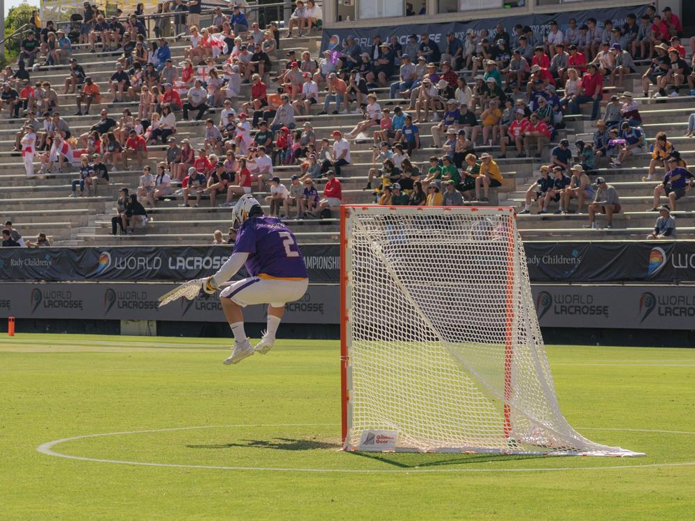 Haudenosaunee Nationals goalie Warren Hill leaps into the air in their match against England - a contest won by Haudenosaunee 18-5.