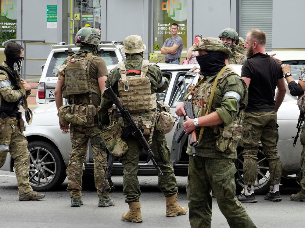 Members of Wagner Group inspect a car in a street of Rostov-on-Don, Russia, on Saturday.