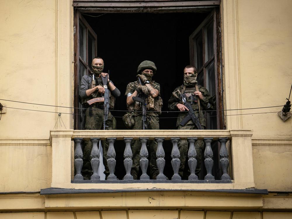 Members of Wagner Group stand on the balcony of a building in the city of Rostov-on-Don on Saturday.