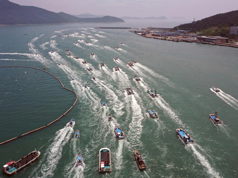 South Korean fishing boats stage a maritime parade to protest against the planned release of treated radioactive water from Japan's wrecked Fukushima nuclear power plant into the sea, on the seas off Wando, South Korea, last Friday.