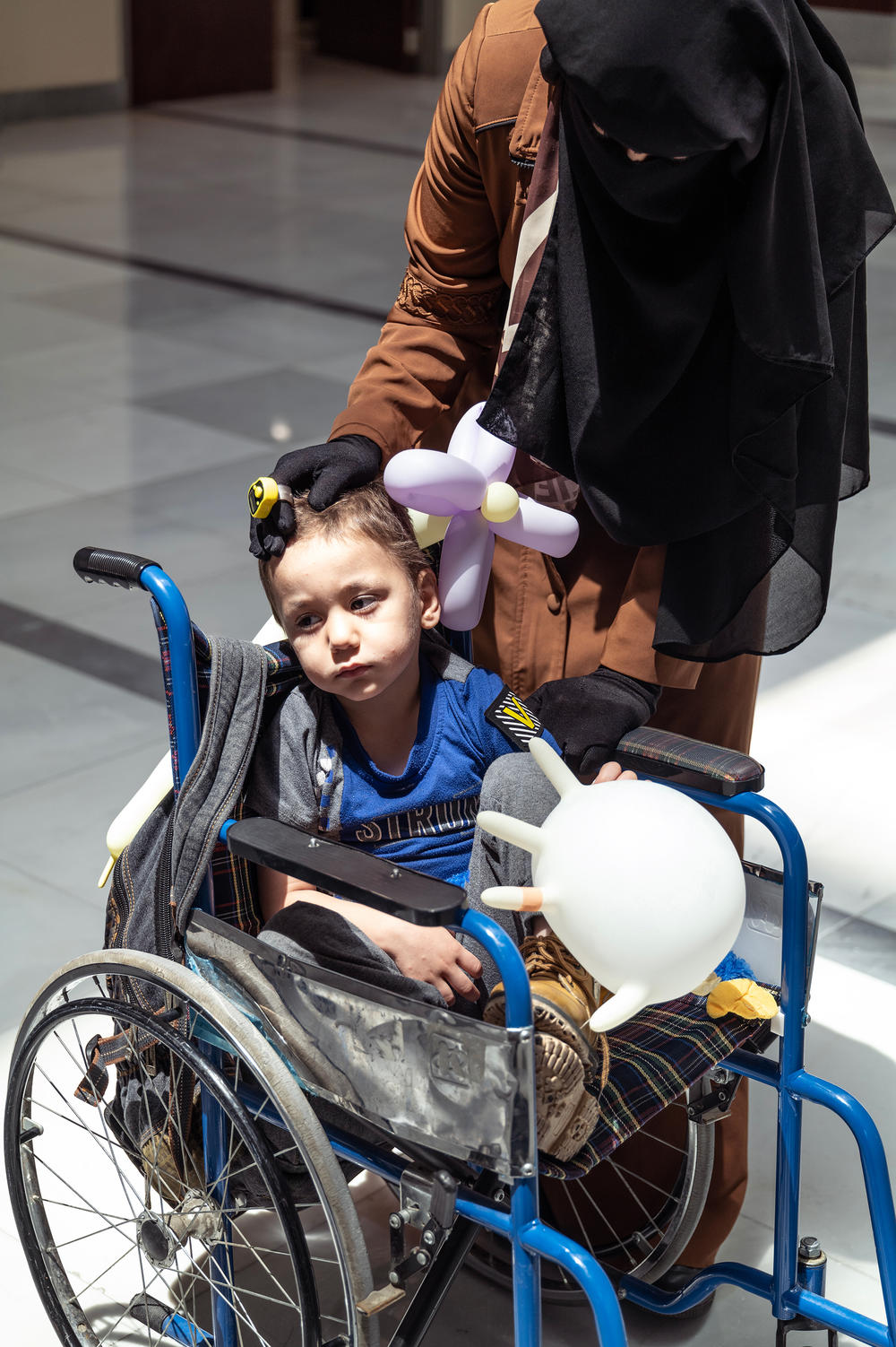 Syrian refugees Narmeen al-Zamel, 34, and her 3-year-old son Khaled wait in the lobby of the King Hussein Cancer Center in Amman, Jordan. Khaled has leukemia and is receiving treatment at this hospital. Khaled's father, Thaer al-Rahal, was one of the people who drowned after the boat they were traveling in sank off Greece.