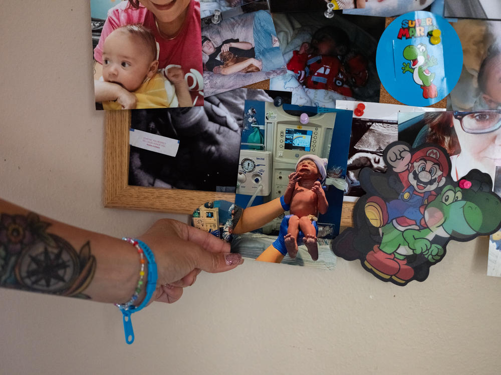 Lorna Weis points out a photo of her son, Isaiah Phoenix, taken the day of his birth. She is working to get him out of foster care.
