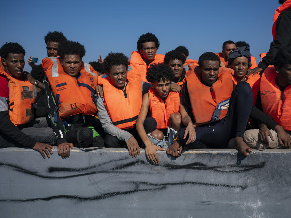 Migrants from Eritrea, Libya and Sudan crowd the deck of a wooden boat as they wait to be assisted by aid workers of the Spanish NGO Open Arms, in the Mediterranean sea about 30 miles north of Libya, on June 17.