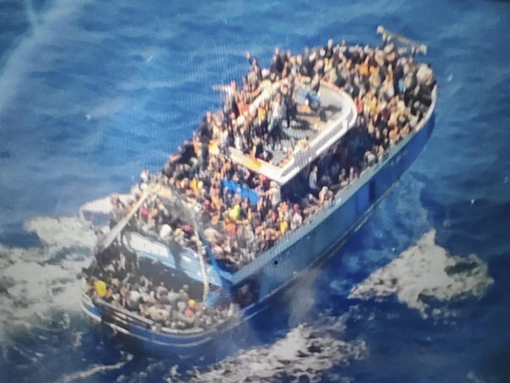 This handout image provided by Greece's coast guard on June 14 shows scores of people on a battered fishing boat that later capsized and sank off southern Greece, drowning hundreds of migrants.