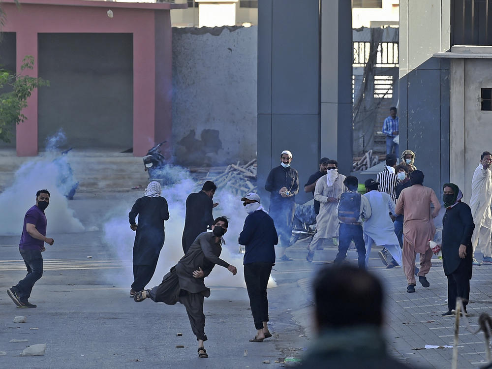 Pakistan Tehreek-e-Insaf party activists and supporters of former Prime Minister Imran Khan clash with police during a protest against the arrest of their leader, in Karachi on May 10.