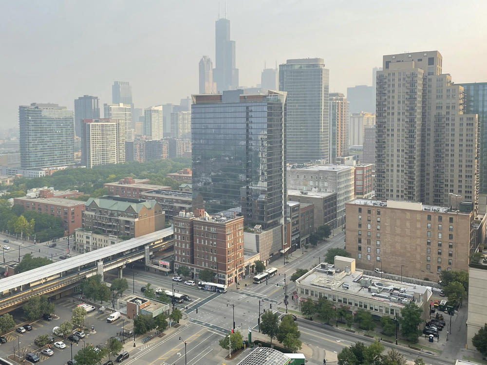 Haze from Canadian wildfires blankets the Chicago skyline as seen from the city's South Loop neighborhood on Wednesday.