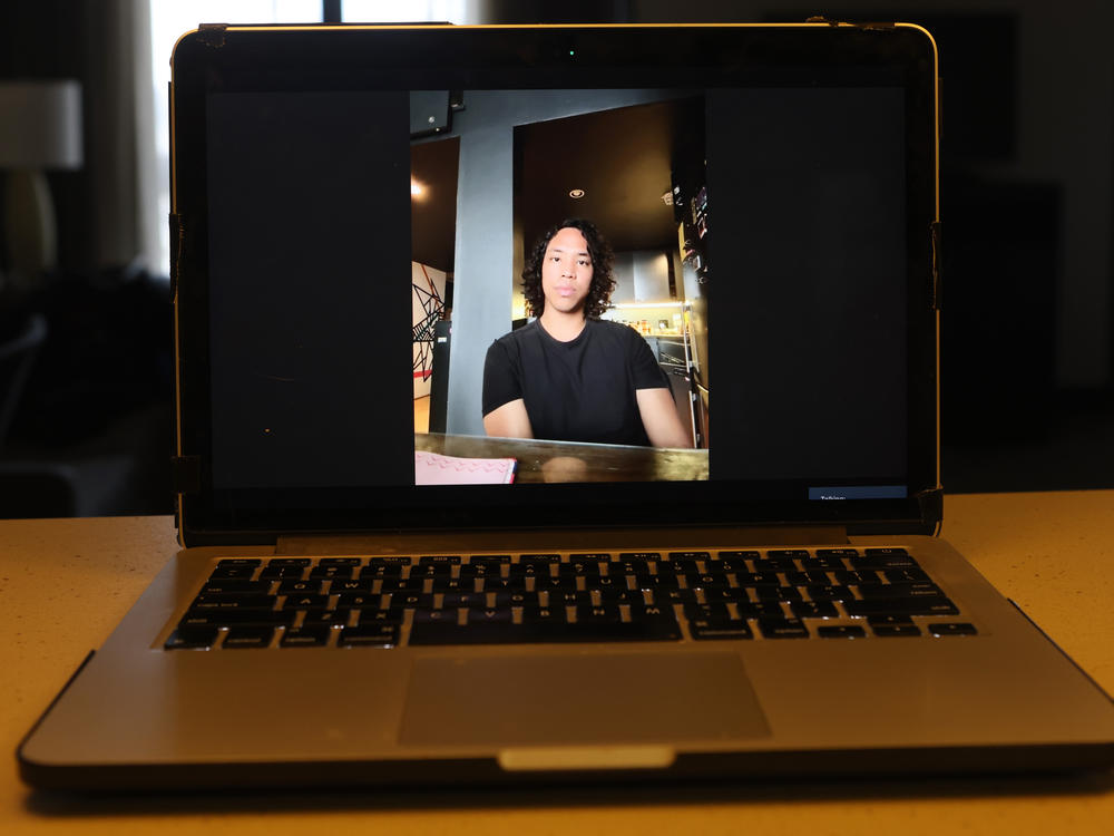Luke Harper, a defendant who has been accused of domestic terrorism, talks via Zoom during an interview with an NPR reporter in Atlanta. He is not allowed to return to Georgia while out on bond, unless it is for a court appearance.