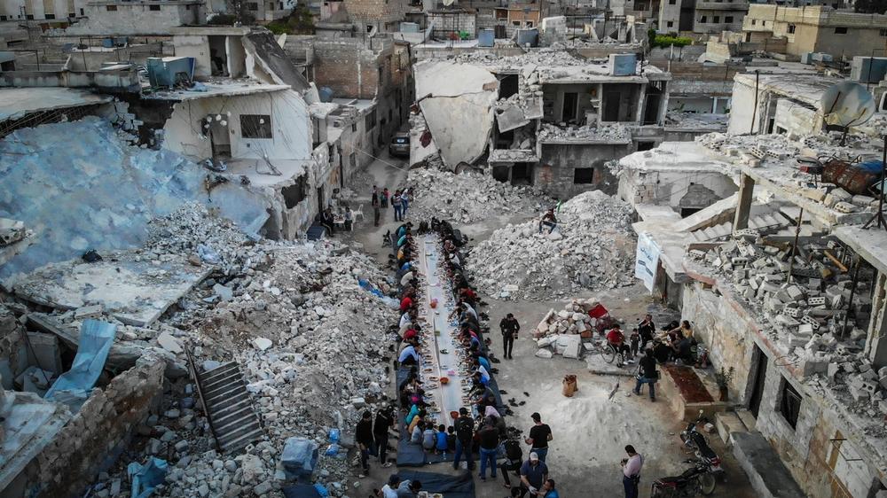 Syrians gather amid the ruins of Idlib for a communal breakfast during the holy month of Ramadan.