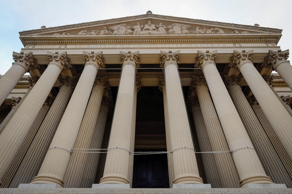The U.S. Archives contain 13.5 <em>billion</em> records. Above the National Archives building in Washington, D.C.