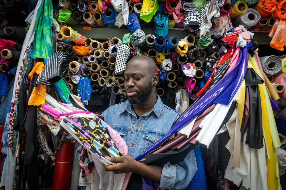Bob The Drag Queen inspects the fabrics at the Spandex House in New York City.