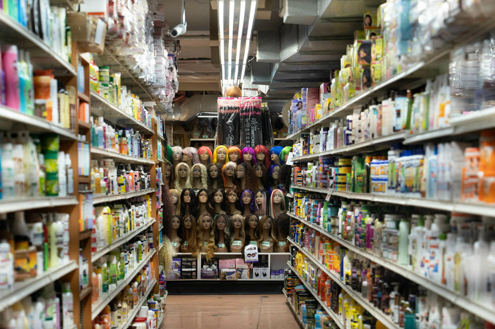 Bob gets his wigs from local beauty supply stores like Manhattan Beauty. A full display of wigs is seen from the aisles in the back of the store.