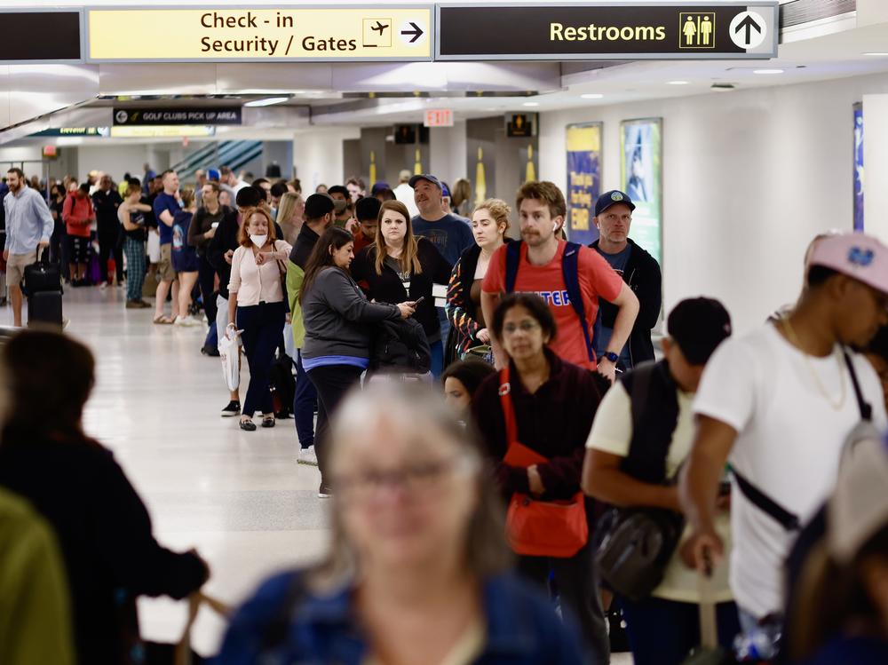 People queue for rescheduled flights at Newark Liberty International Airport in New Jersey on Tuesday.