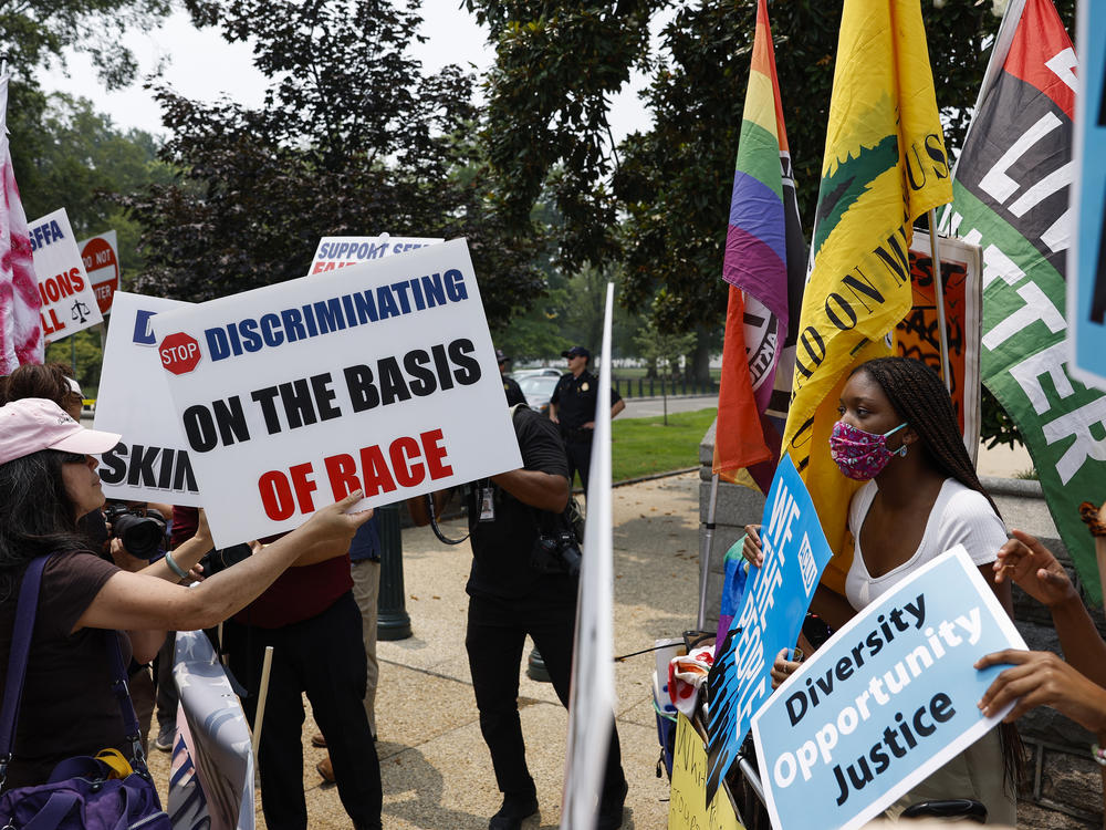 Protesters for and against affirmative action demonstrate on Capitol Hill on Thursday. The Supreme Court ruled that race-conscious admissions programs at Harvard University and the University of North Carolina are unconstitutional.