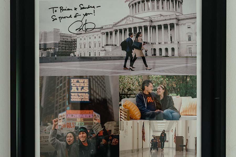 A photograph collage of ALS advocacy moments hangs on the wall of Wallach's home office.