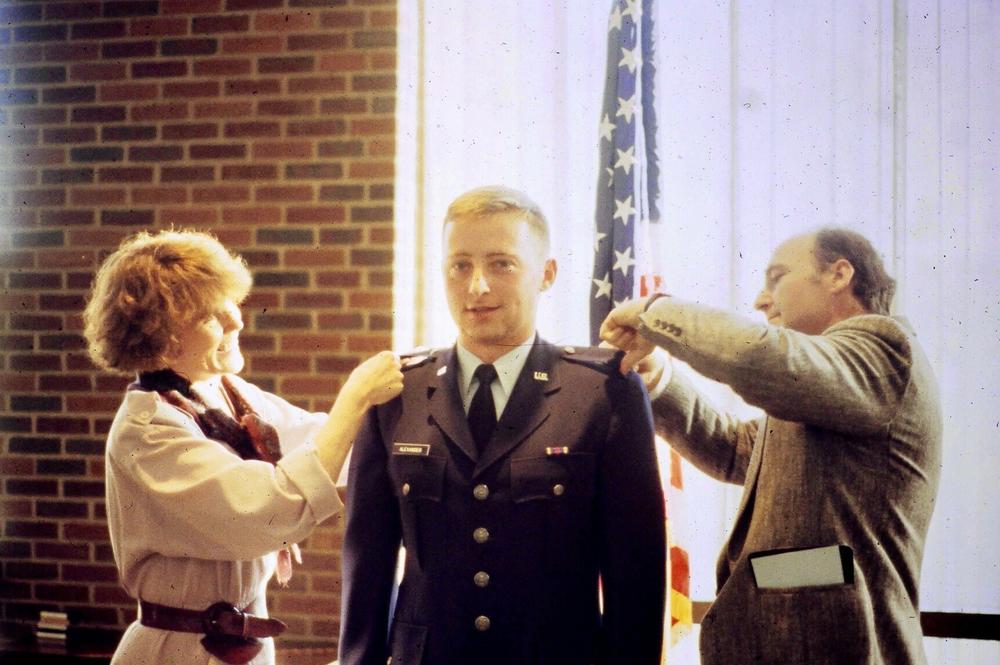 Robert Alexander getting his 2nd lieutenant bars pinned by his parents at his commissioning.