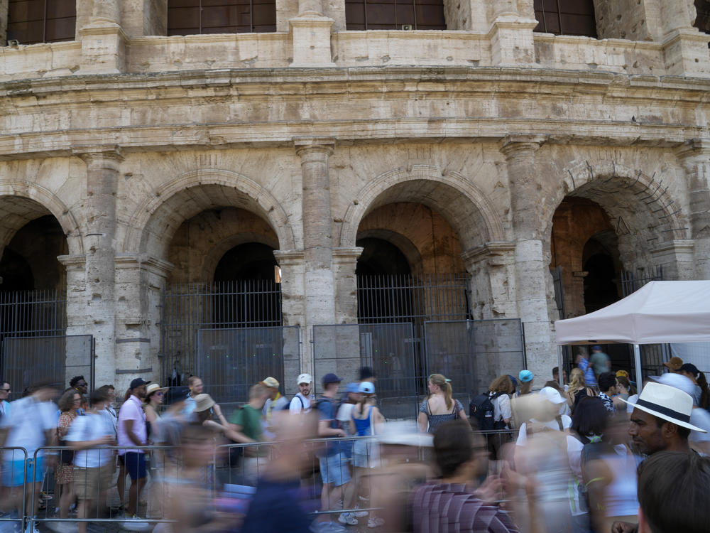Visitors stand in a line to enter the ancient Colosseum, in Rome, Tuesday, June 27, 2023. Italian police on Thursday, June 29, 2023, said they believe the person who was filmed while engraving his name on the ancient Roman Colosseum is a tourist who lives in Britain. Italian law enforcement said in a release that the identification was made using photographic comparisons.