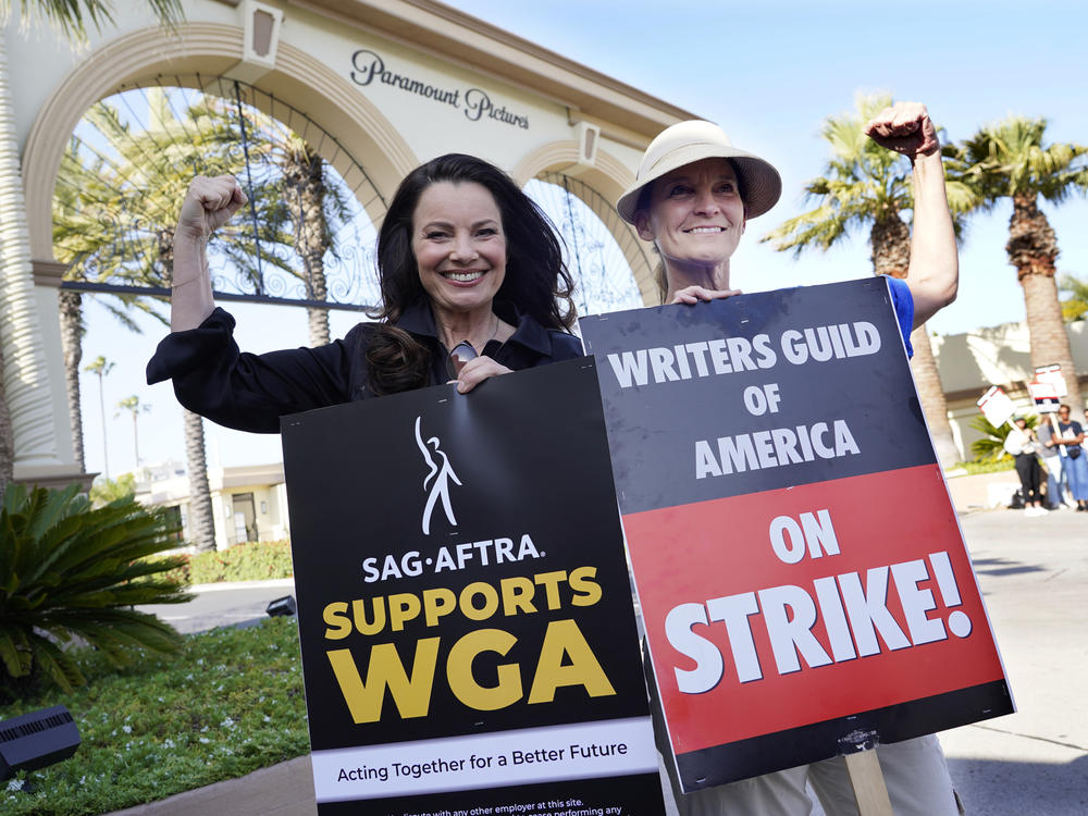 Fran Drescher (left), president of SAG-AFTRA, and Meredith Stiehm, president of Writers Guild of America West, pose together during a rally by striking writers outside Paramount Pictures studio in Los Angeles on May 8.