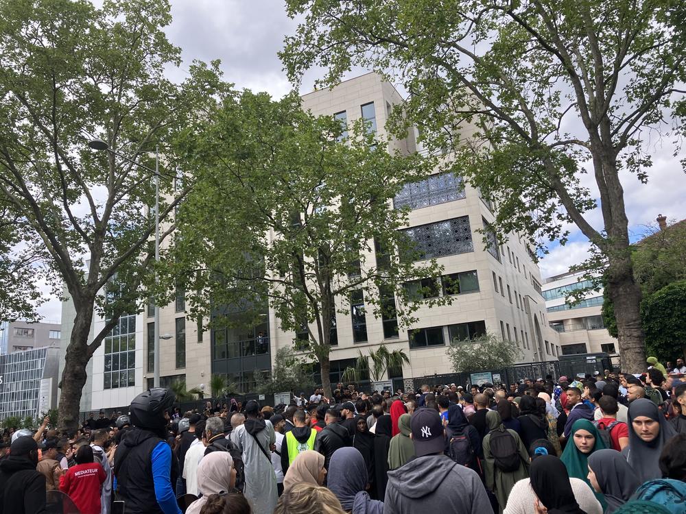 A crowd gathers in front of the Ibn Badis mosque where mourners gathered to pay respects Saturday in Nanterre, France.