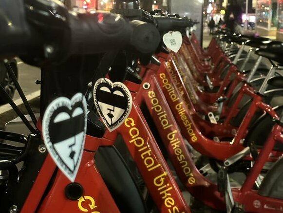Art supporting the protests in Iran has moved to the streets, affixed here on bikeshares in Washington, D.C.