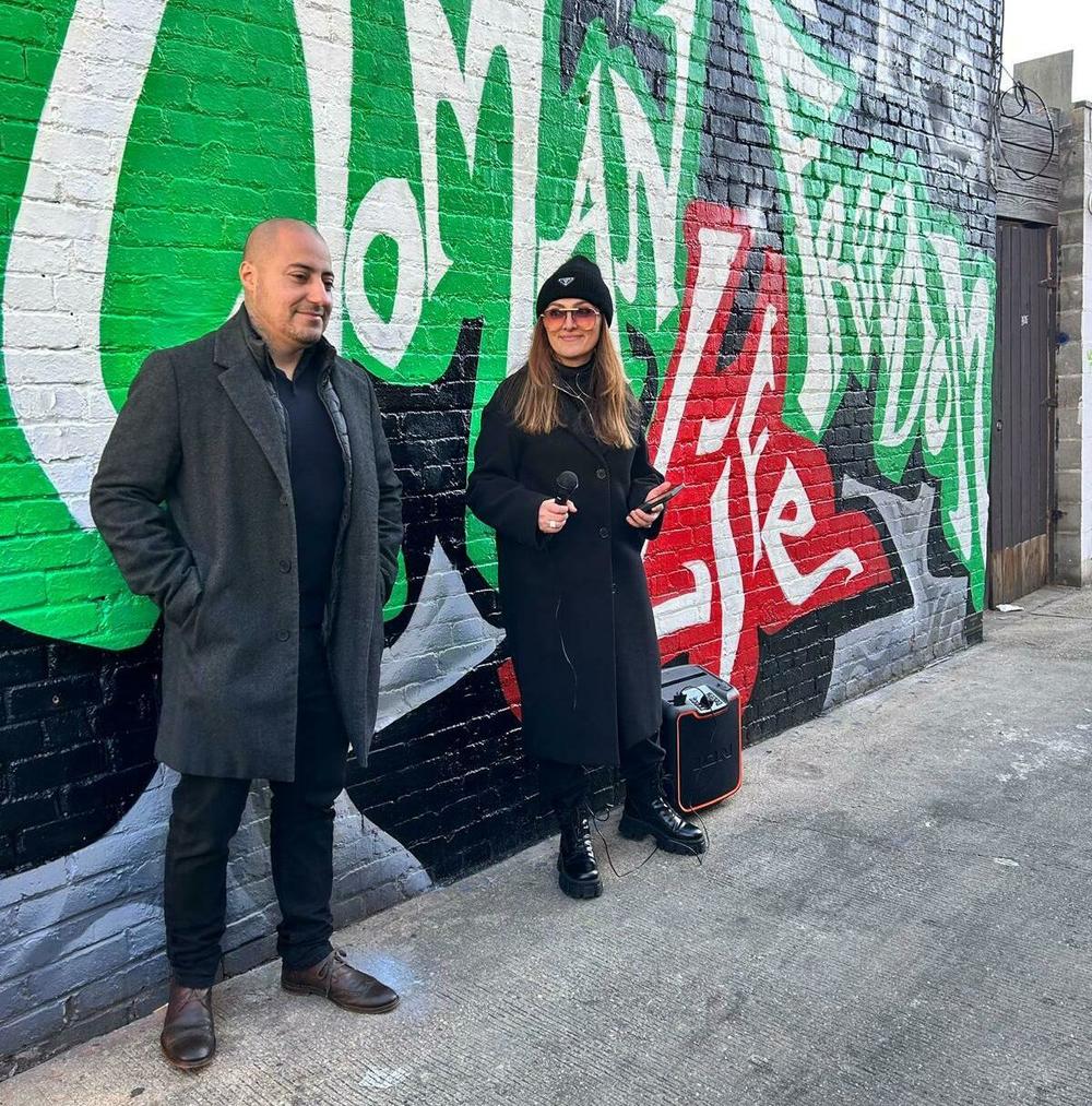 Rodrigo Pradel and Yasi Farazad stand in front of the mural Pradel painted in Washington, D.C. during the unveiling event of the mural on Jan. 15.