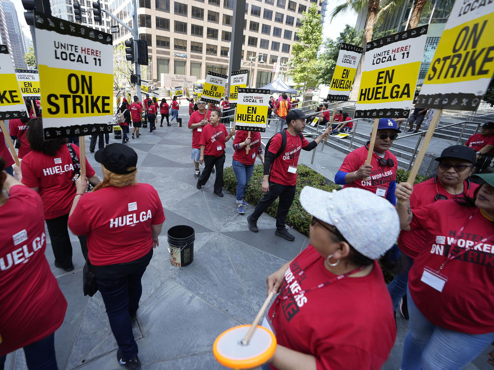 Striking hotel workers rally outside the InterContinental Hotel after walking off their job early Sunday, July 2, 2023, in downtown Los Angeles.