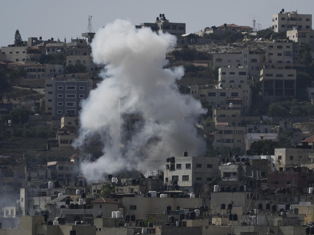 Smoke rises during an Israeli military raid of the militant stronghold of Jenin in the occupied West Bank, Monday, July 3, 2023.