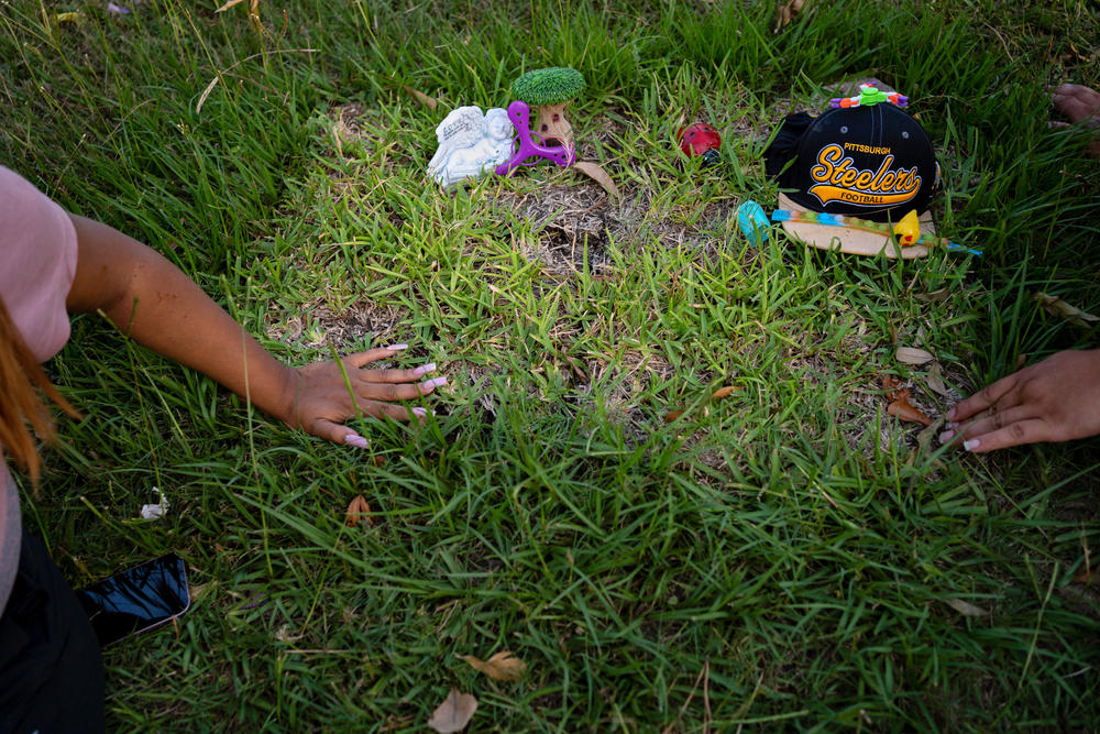 Samantha Casiano and her husband, Luis Fernando Villasana, pause at baby Halo's gravesite on June 24. Villasana had held out hope that Halo might be OK; the baby died in his arms.