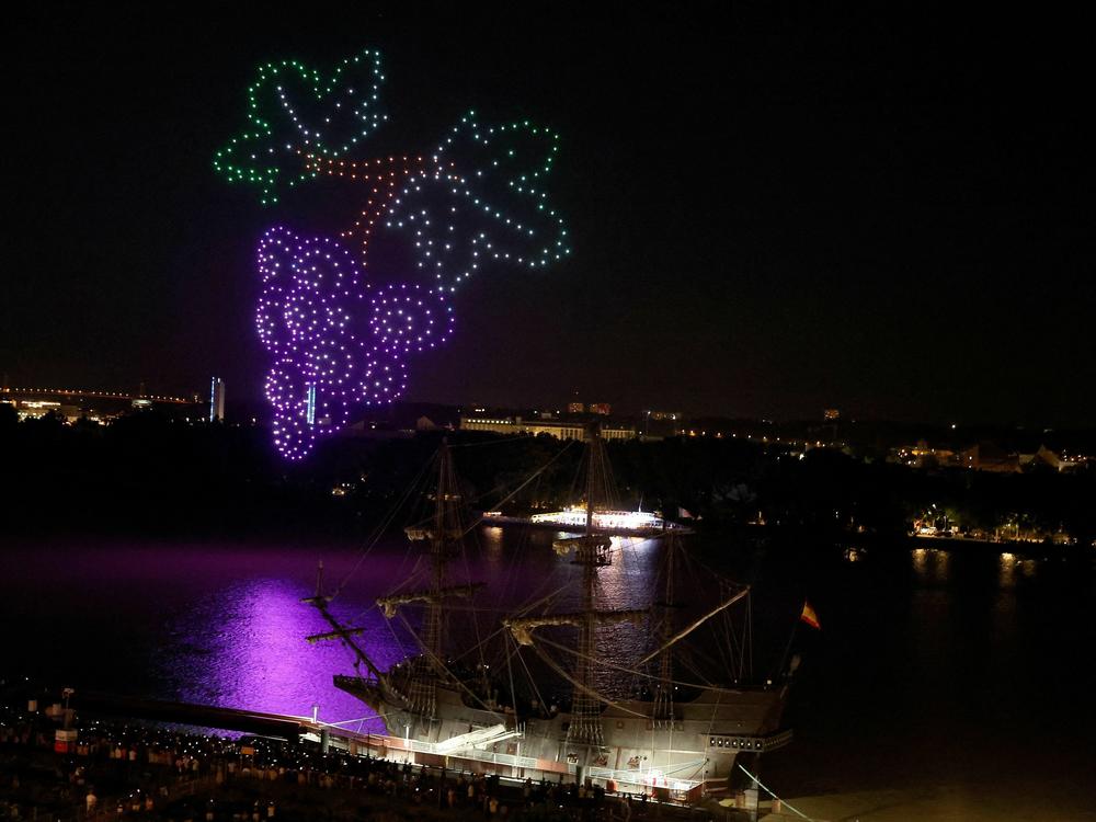 An aerial drone display by approximately 500 drones hovers over the Garonne River in Bordeaux, France on June 23, 2023. Some U.S. cities are planning their own drone shows as an alternative to Fourth of July fireworks.