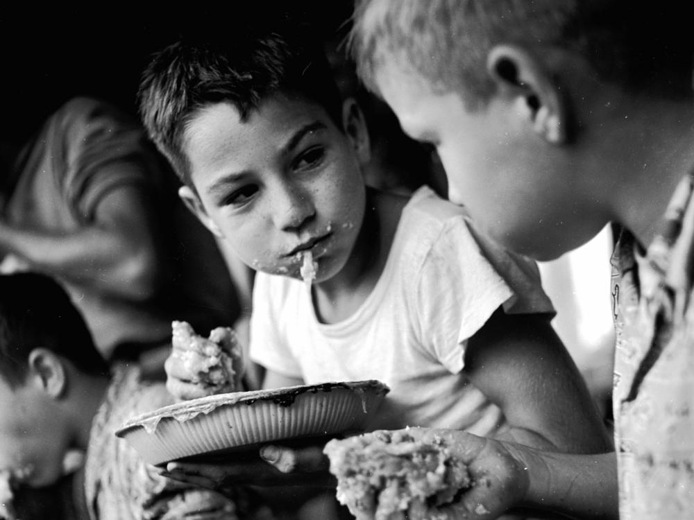 Two young boys pause for breath during an apple pie eating contest during Big Apple Day in Ohio, circa 1947.