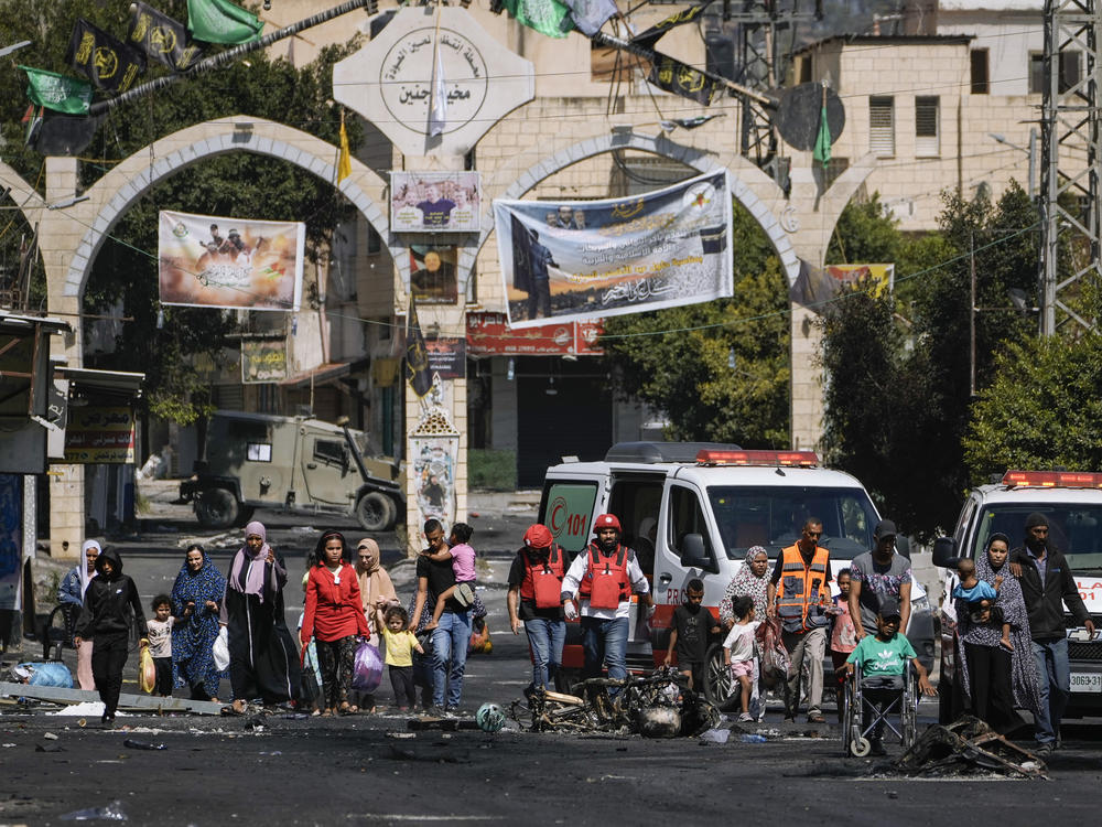 Residents of the Jenin refugee camp fled their homes as the Israeli military pressed ahead with an operation in the area, in Jenin, West Bank, Tuesday. Palestinian health officials put the Palestinian death toll from the two-day raid at 10. The Israeli military said Israel launched the operation because some 50 attacks over the past year had emanated from Jenin.