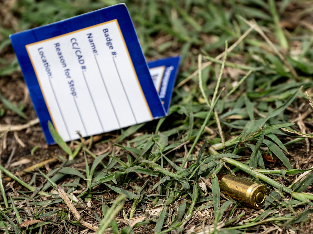 A bullet casing is seen at the site of a mass shooting in the Brooklyn Homes neighborhood in Baltimore, Maryland, on Sunday. Two people were killed and 28 others were wounded during the shooting at a block party on Saturday night.