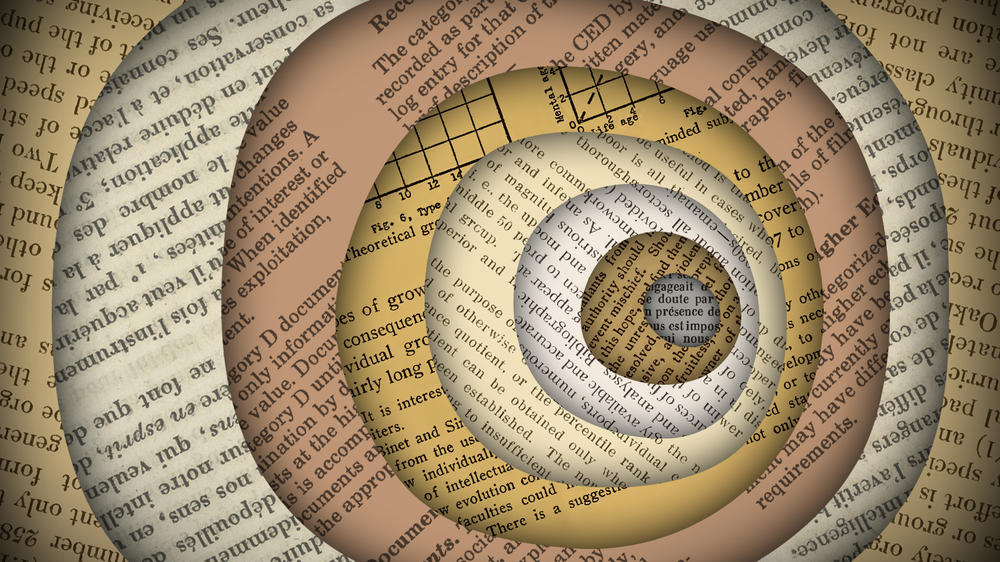 A deep hole dug from layers of paper covered with text.