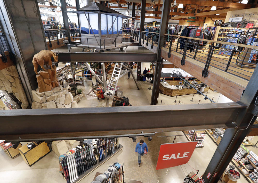 A shopper walks through REI's store in Seattle in 2018.