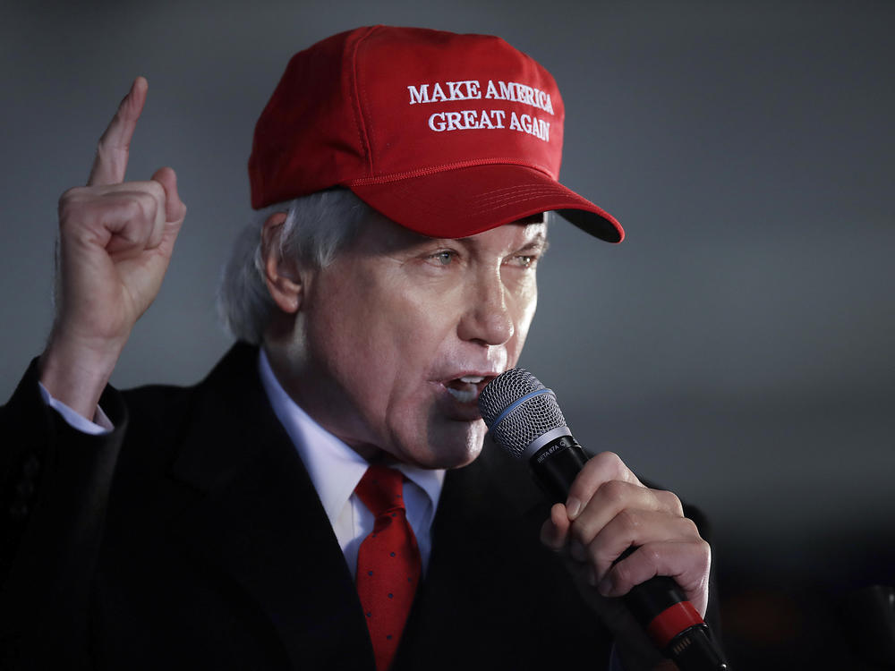 In this Dec. 2, 2020 file photo, attorney Lin Wood gestures while speaking during a rally in Alpharetta, Ga. Wood has asked officials in his home state of Georgia to retire his law license.