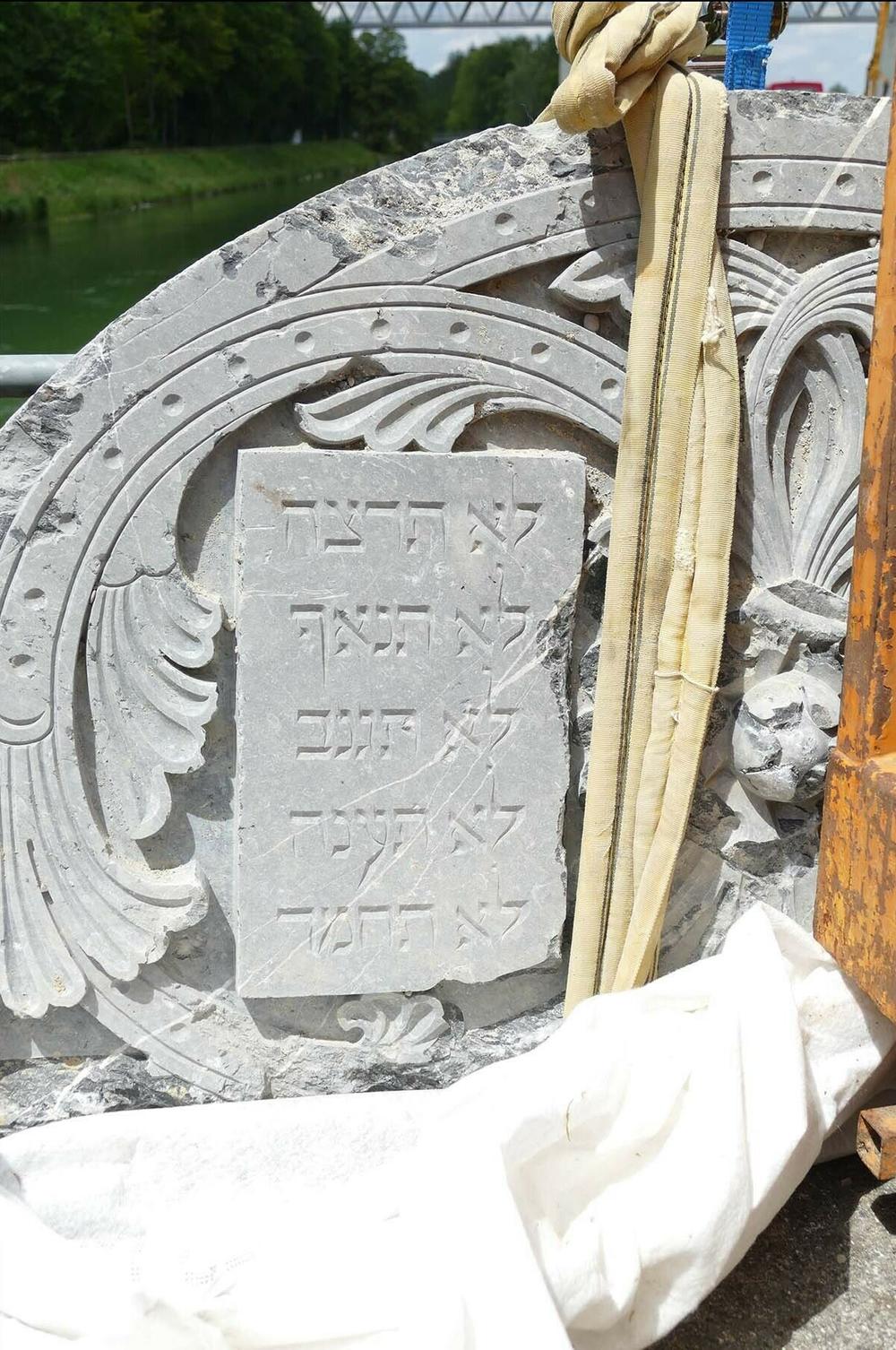 Fragments of the synagogue's marble Torah shrine at the discovery site of the rubble in the Isar river in Munich.
