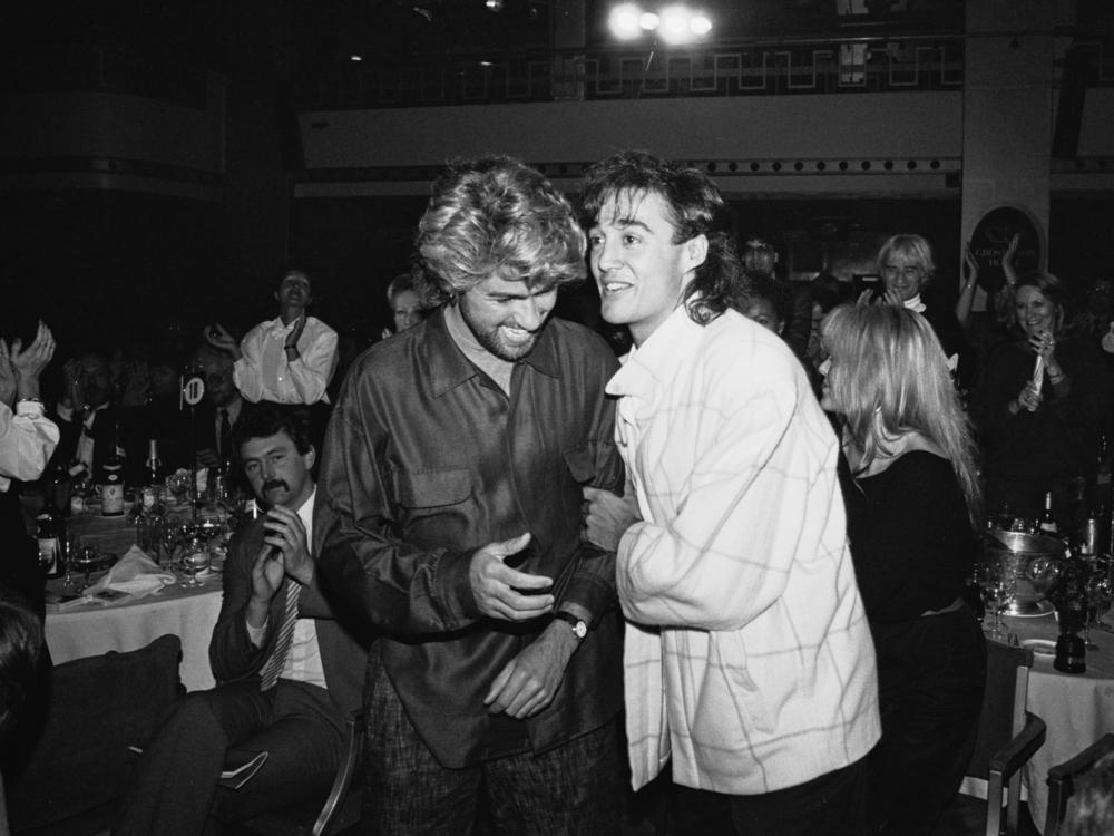 English singer-songwriters George Michael (1963 - 2016) and Andrew Ridgeley of pop duo Wham! at the Ivor Novello Awards, UK, 14th March 1985.